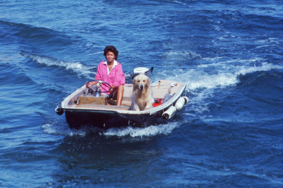 Woman and dog in motorboat
